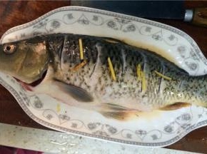 用葱、姜、料酒、花椒和少许清水将鲤鱼腌制40分钟，去除鱼腥味
