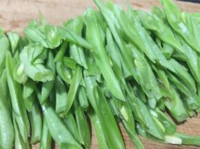 四季豆撕筋去头尾，斜切成丝