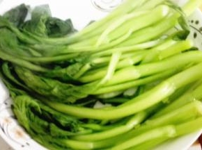 菜心焯熟之后沥干摆入盘子中
