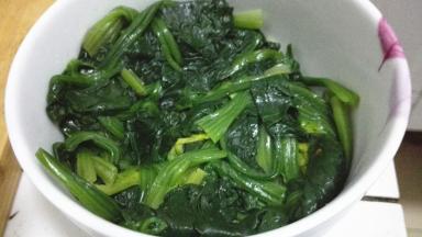 将菠菜压实在容器中，倒扣在盘子上