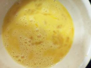 将鸡蛋打入碗中，加入牛奶和盐，朝一个方向搅拌均匀