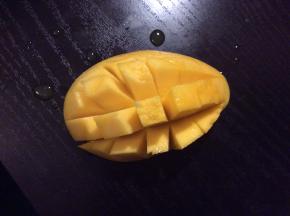 把芒果分左中右切片，用刀划十字切丁