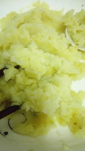 蒸好的土豆用勺子压成土豆泥