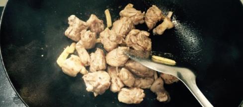 将鸭块倒入锅内，翻炒至双面金黄，煸出肥油