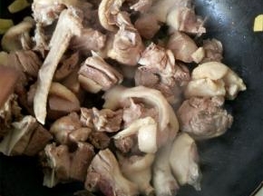 放入花椒粒和焯好的鸭块，煸炒出肥油