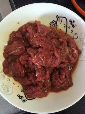 牛里脊切成片状，用少量的淀粉，料酒和盐抓拌均匀，腌制15分钟