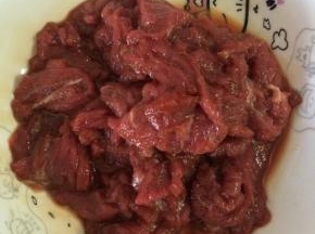 牛里脊切成片状，用少量的淀粉，料酒和盐抓拌均匀，腌制15分钟