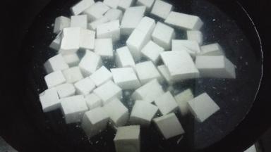 锅内加水烧开，放入切好的豆腐