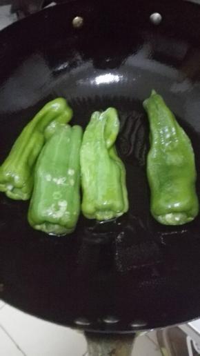 锅内放入少许的油，油温5分热的时候翻入青椒