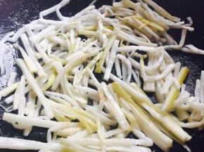 放入酸笋和适量的辣椒油翻炒