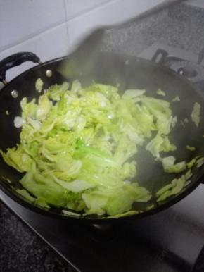2分钟后，包菜炒制出水耙软，加盐调味出锅