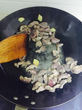 锅中放姜片和鸡胗，翻炒至变色