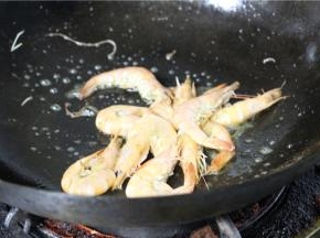 然后倒入鲜虾翻炒，使其变色