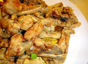 田鸡加生抽、淀粉进行腌制片刻。起油锅，将切好的田鸡肉入油锅下炸，炸成金黄后捞出沥干