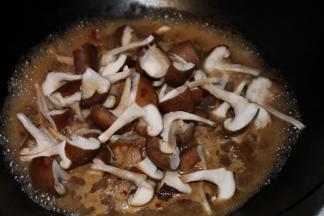 香菇对半手撕成块，倒入沸腾的锅中，加盖煮开