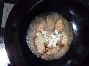 鸡翅炒6分熟后，倒入可乐，放上葱蒜片，加盖大火焖煮