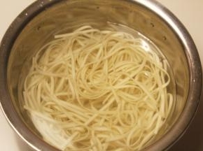 锅里烧水，水煮开后放上面条煮熟捞出，放在凉水中浸泡，用筷子搅拌，防止面条粘连