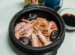将炒制好的虾及辅料有成次的铺垫于黑砂锅中，将适量的生抽、耗油、花雕酒、水混合调制成汁，然后浇于锅中食材之上，略微和虾齐平为好
