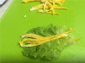 将切好的鸡蛋丝卷入，用牙签固定。