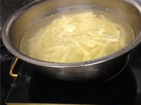 将土豆块放入盐水中泡制5分钟，然后将水煮沸，把土豆放进去煮1-2分钟取出。