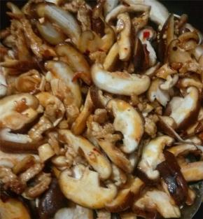 翻炒一会后，倒入香菇