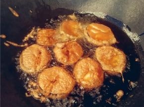 依次夹入茄饼油炸，适时翻面