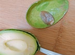 用勺子沿着果皮边缘慢慢掏出果肉。