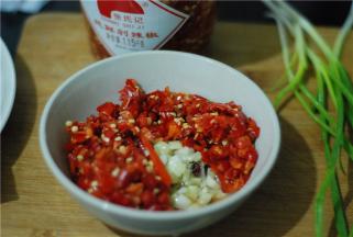 炒好的姜蒜装小碗，加入三勺剁椒，加盐、鸡精拌匀