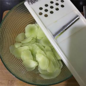 用擦片工具把去了皮的莴笋擦出薄薄的一片