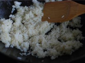 热锅倒少量油，把米饭倒进去翻炒，尽量把每一粒米都炒散