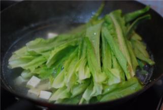 翻腾2-3分钟后，把莴笋叶放进来