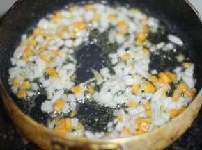 锅内倒少许的油，油热放入洋葱煸直半透明，倒入青豆，胡萝卜和火腿翻炒至断生