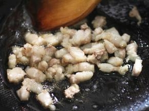 锅内重新倒油，油热之后放入肉丁翻炒至变色