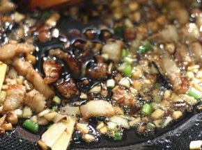 加入适量的老抽和黄酒翻炒至均匀上色