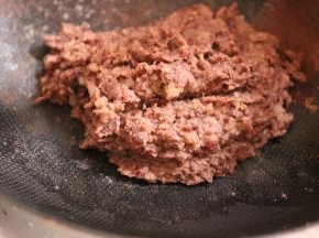 倒入刚刚做好的红豆沙，小火翻炒至豆沙偏干，搅动费劲即可