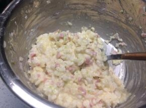 在米饭中加入洋葱、火腿肠和西葫芦，打入鸡蛋搅拌均匀，加入盐调味后，再加一勺面粉使所有材料能够粘稠成团。