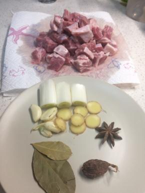 牛腩切小块放清水里浸泡去血水，多换几次水直到无血水渗出，放厨房纸吸干表面水分备用。葱切大段，姜切片，大蒜拍扁备用。