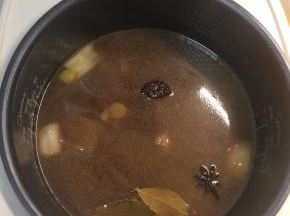 加入食盐调味，翻炒均匀后加入足量热水转至有煲汤功能的电饭锅或炖锅中小火慢炖。