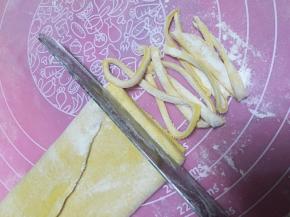 将面团擀开，撒上面粉，切条