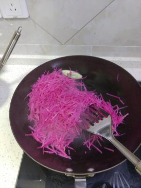 锅内放油加热放入葱蒜爆香，加入萝卜丝进行翻炒