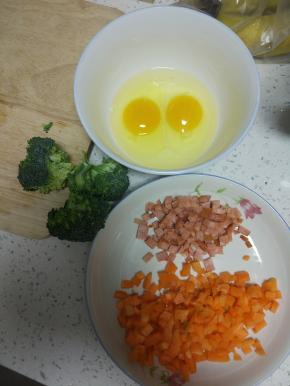西兰花、胡萝卜、火腿肠切丁，葱切葱花，鸡蛋打散备用