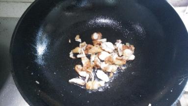 在锅内倒入适量的花生油，新奥尔良鸡肉切片翻炒