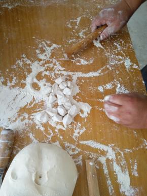 将发酵的面粉揉成长条，切成一颗颗的小块状，然后用擀面杖弄成圆圆的一张张。
