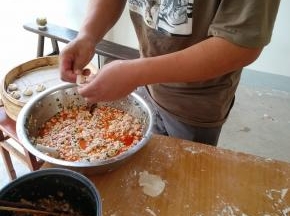 左手拿皮， 右手拿筷子放适量的豆腐馅、肉馅，喜欢豆腐馅的可以多放些豆腐；喜欢肉馅的可以多放些肉沫