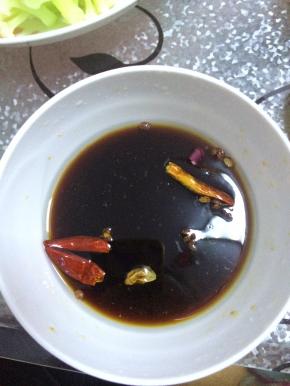 碗内倒入味达美，醋香油等，加入适量盐搅拌均匀。辣椒在锅内煸一下放入调好的调料中。