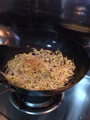 锅内放入适量食用油，盐，姜丝。把豆芽放入锅内翻炒。