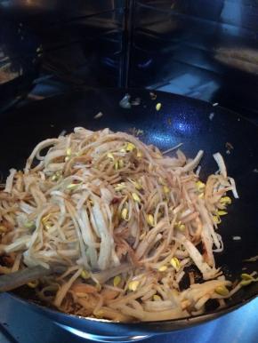 豆芽大火翻炒3分钟左右，放入饼丝转小火。