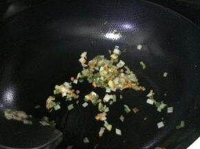 把炸好的土豆放入锅内，加入适量的葱花。