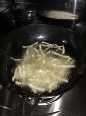 把薯条放入锅内，炸至微黄。捞出