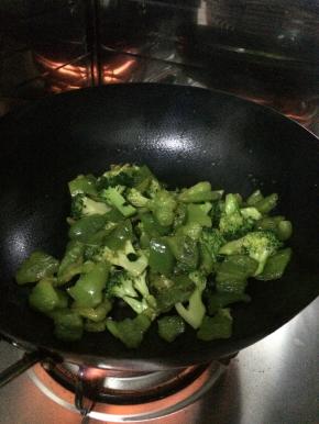 锅内放入适量的油加入调料，把菜花和青椒放入锅中翻炒。